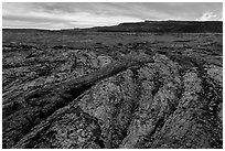 Olivine-rich lava and Mokuaweoweo crater, Mauna Loa North Pit. Hawaii Volcanoes National Park, Hawaii, USA. (black and white)