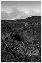 Red and orange lava, rainbow in clouds, Mauna Loa. Hawaii Volcanoes National Park, Hawaii, USA. (black and white)