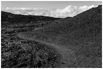 Trail through olivine hill bordering aa lava. Hawaii Volcanoes National Park, Hawaii, USA. (black and white)