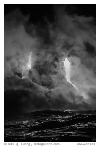 Lava cascading cliffs above ocean waves at night. Hawaii Volcanoes National Park, Hawaii, USA.