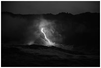 Waves, lava flow, and cliffs. Hawaii Volcanoes National Park, Hawaii, USA. (black and white)