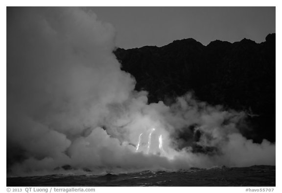 Lava flows cascade down sea cliff at dawn. Hawaii Volcanoes National Park, Hawaii, USA.