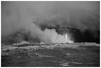 Lava flows creating huge clouds of hydrochloric steam upon meeting with ocean. Hawaii Volcanoes National Park, Hawaii, USA. (black and white)