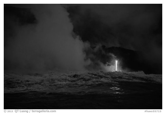 Lava runs down the cliff and goes into the sea at dawn. Hawaii Volcanoes National Park (black and white)