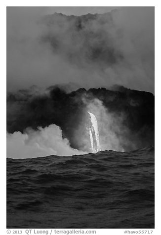 A single spigot of lava creates a large plume steam at sunrise upon reaching ocean. Hawaii Volcanoes National Park, Hawaii, USA.