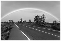 Rainbow over highway. Hawaii Volcanoes National Park, Hawaii, USA. (black and white)