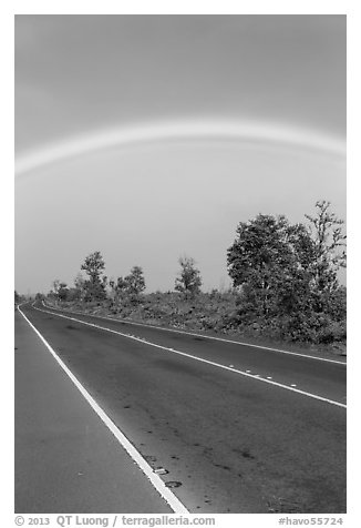 Rainbow above highway. Hawaii Volcanoes National Park, Hawaii, USA.