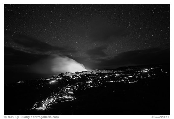 Molten lava flow and plume from ocean entry with stary sky at night. Hawaii Volcanoes National Park (black and white)