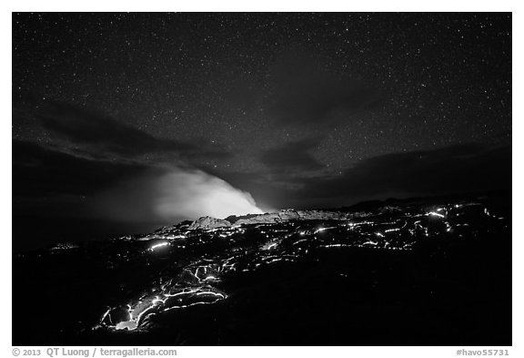 Molten lava flow and plume from ocean entry with stary sky at night. Hawaii Volcanoes National Park, Hawaii, USA.