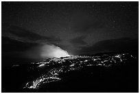 Molten lava flow and plume from ocean entry with stary sky at night. Hawaii Volcanoes National Park ( black and white)