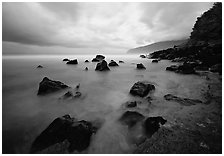 Seascape with smooth water, clouds and rocks, Siu Point, Tau Island. National Park of American Samoa (black and white)