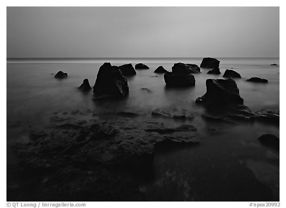 Rocks in water at dusk, Siu Point, Tau Island. National Park of American Samoa (black and white)