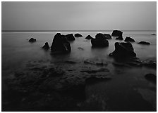 Rocks in water at dusk, Siu Point, Tau Island. National Park of American Samoa (black and white)