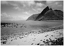 Tropical beach with sand and pebbles, and pointed peaks of Ofu Island. National Park of American Samoa ( black and white)