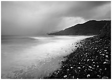 Coastline with dark rocks, light water and storm sky at sunrise, Vatia bay, Tutuila Island. National Park of American Samoa (black and white)