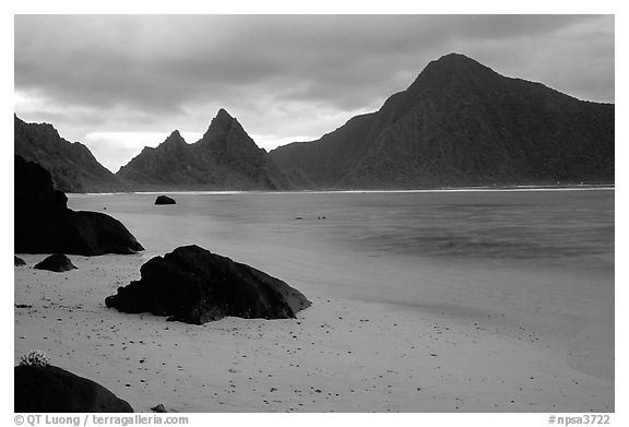 Balsalt boulders on South Beach, Sunuitao Peak and Piumafua mountain on Olosega Island in the background, Ofu Island. National Park of American Samoa