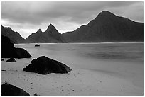 Balsalt boulders on South Beach, Sunuitao Peak and Piumafua mountain on Olosega Island in the background, Ofu Island. National Park of American Samoa ( black and white)