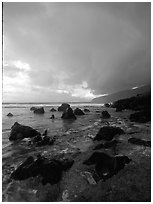 Boulders and coastline at sunrise with rainbow, Siu Point, Tau Island. National Park of American Samoa ( black and white)