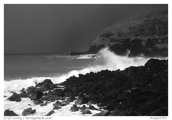 Dark boulders, crashing waves, and dark sky, storm light, Tau Island. National Park of American Samoa (black and white)