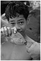 Samoan boy with freshly catched tropical fish, Tau Island. National Park of American Samoa (black and white)