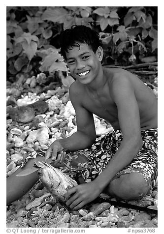 Samoan boy with fish, Tau Island. National Park of American Samoa (black and white)