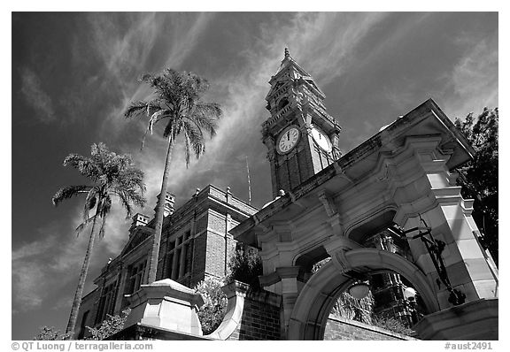 South Brisbane Town Hall, a red brick building with an ornate clock tower and archway. Brisbane, Queensland, Australia (black and white)