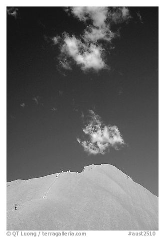 Hikers ascend Ayers Rock. Uluru-Kata Tjuta National Park, Northern Territories, Australia (black and white)