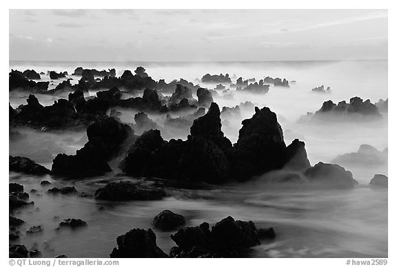 Volcanic rocks and waves at sunrise, Keanae Peninsula. Maui, Hawaii, USA