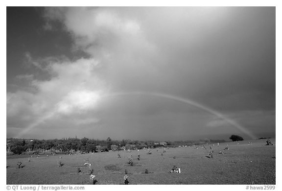 Rainbow over grassy cemetery. Maui, Hawaii, USA