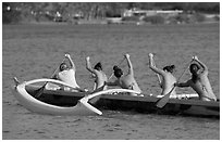 Back view of women in bikini paddling a outrigger canoe, Maunalua Bay, late afternoon. Oahu island, Hawaii, USA ( black and white)