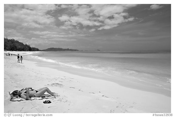 Woman sunning herself on Waimanalo Beach. Oahu island, Hawaii, USA (black and white)