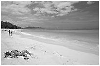 Woman sunning herself on Waimanalo Beach. Oahu island, Hawaii, USA ( black and white)