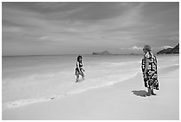 Two women, the Older in hawaiian dress, on Waimanalo Beach. Oahu island, Hawaii, USA (black and white)