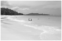 Couple and other bathers in the water, Waimanalo Beach. Oahu island, Hawaii, USA (black and white)