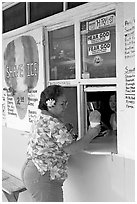 Woman with a flower in hair getting shave ice, Waimanalo. Oahu island, Hawaii, USA ( black and white)