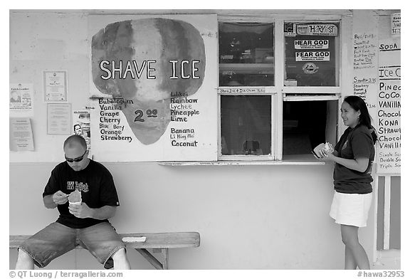 Shave ice store with man sitting eating and woman ordering, Waimanalo. Oahu island, Hawaii, USA (black and white)