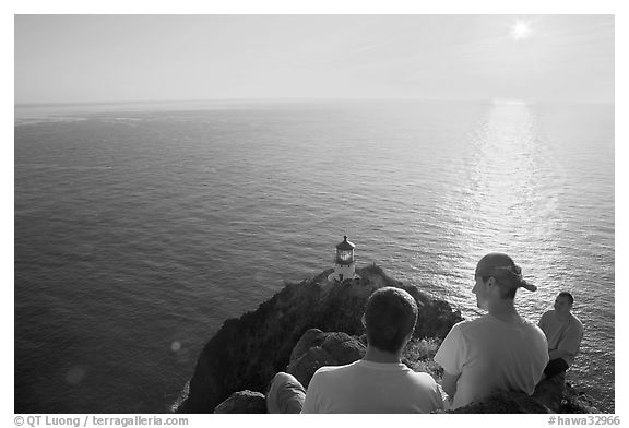 Men above the Makapuu head ligthouse, early morning. Oahu island, Hawaii, USA (black and white)