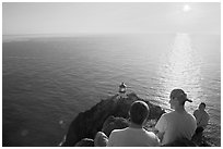 Men above the Makapuu head ligthouse, early morning. Oahu island, Hawaii, USA (black and white)