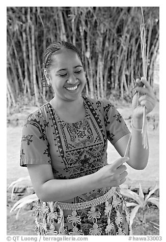 Tonga woman showing how to make cloth out of Mulberry bark. Polynesian Cultural Center, Oahu island, Hawaii, USA