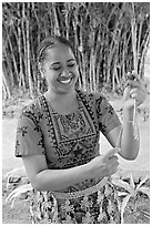 Tonga woman showing how to make cloth out of Mulberry bark. Polynesian Cultural Center, Oahu island, Hawaii, USA (black and white)
