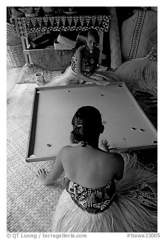 Fiji women playing a traditional game similar to pool. Polynesian Cultural Center, Oahu island, Hawaii, USA (black and white)