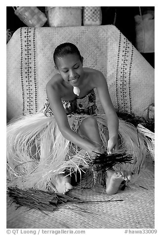 Fiji woman using her feet to tie leaves. Polynesian Cultural Center, Oahu island, Hawaii, USA