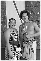 Maori woman and man sticking out his tongue. Polynesian Cultural Center, Oahu island, Hawaii, USA (black and white)