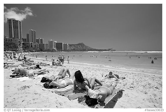 Young women sunning on Waikiki Beach. Waikiki, Honolulu, Oahu island, Hawaii, USA