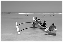 Outrigger canoe lauching from Waikiki Beach. Waikiki, Honolulu, Oahu island, Hawaii, USA ( black and white)