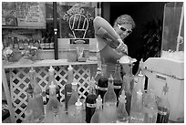 Woman preparing a cup of shave ice. Waikiki, Honolulu, Oahu island, Hawaii, USA (black and white)