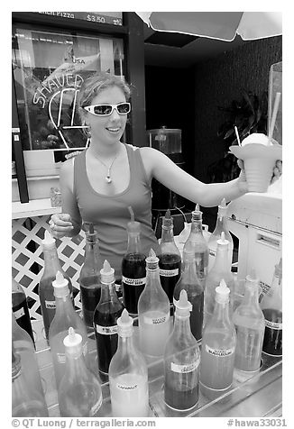 Woman handing out a cup of shave ice. Waikiki, Honolulu, Oahu island, Hawaii, USA (black and white)