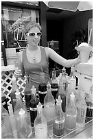 Woman handing out a cup of shave ice. Waikiki, Honolulu, Oahu island, Hawaii, USA (black and white)