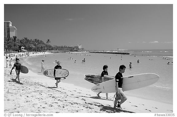 Men walking on Waikiki Beach with surfboards. Waikiki, Honolulu, Oahu island, Hawaii, USA