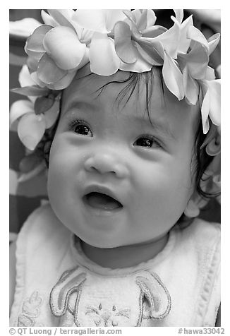 Baby girl wearing a flower lei on her head. Waikiki, Honolulu, Oahu island, Hawaii, USA (black and white)